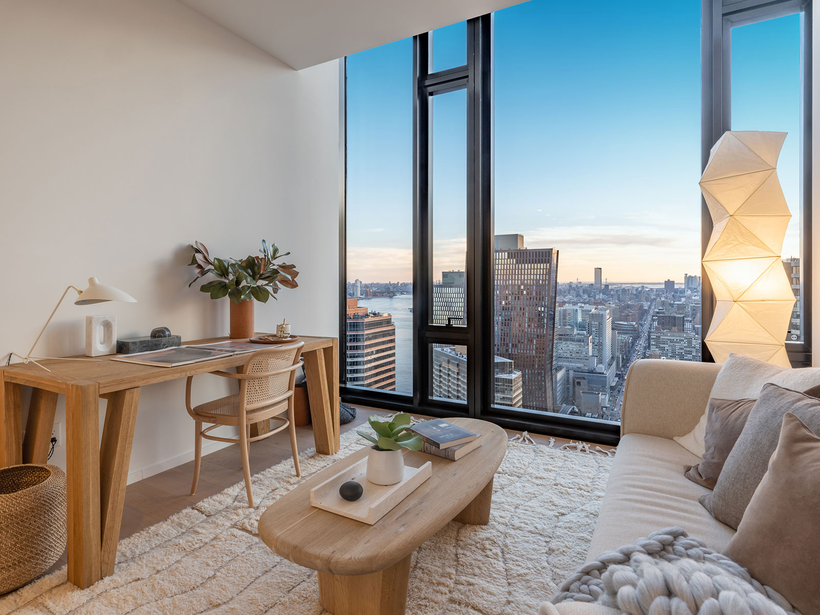 Modern living room offering stunning Manhattan skyline views for residents at 685 1st ave, apartments for rent in Murray Hill