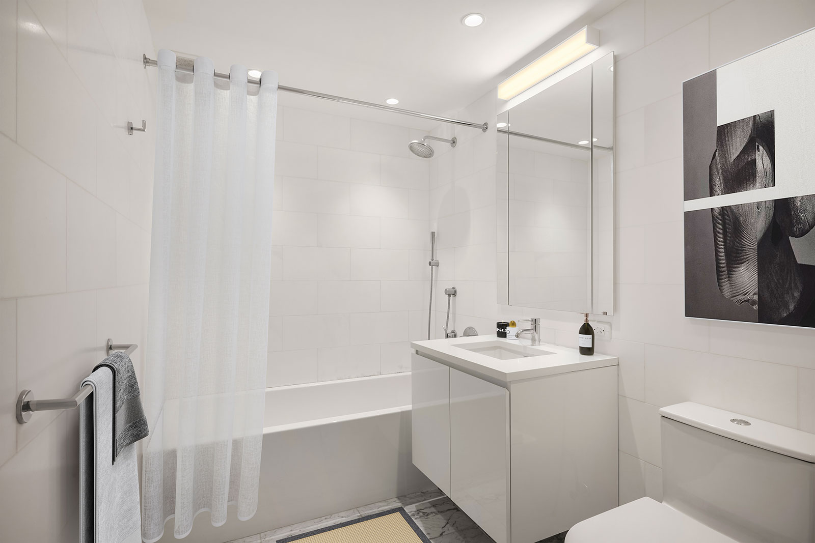 Modern bathroom with sleek finishes, and a bathtub/shower combo at 685 First Avenue, apartments for rent in Murray Hill.