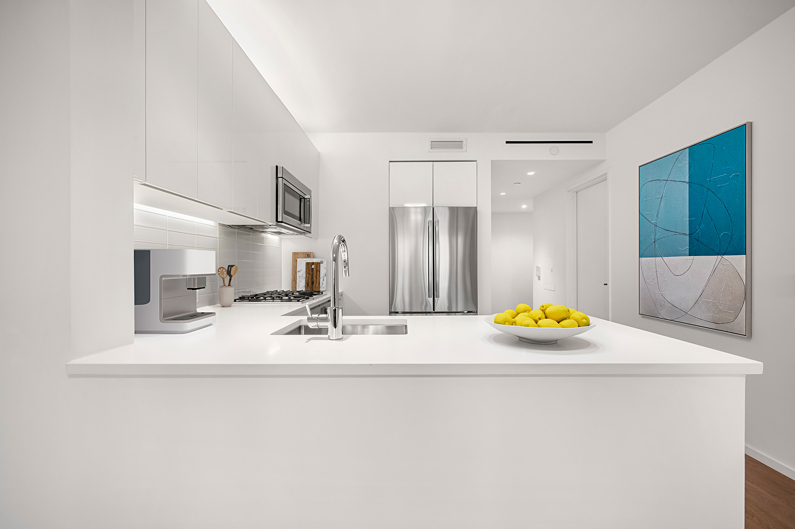 Modern kitchen with white countertops, sleek finishes, and open layout at 685 First Avenue, apartments renals Murray Hill.